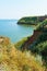 Beautiful summer seascape, seashore on a bright day, high hill and wild grass