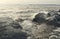 Beautiful summer season specific photograph. Large boulders and rocks together with stormy/rough sea and waves. Lovely lights and