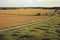 Beautiful summer season specific photograph. Summer fields and road/pathwalk. Photo showing a city center in the far horizon. Upps