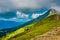 Beautiful Summer sunny mountains with clouds and meadow