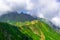 Beautiful Summer sunny mountains with clouds and meadow