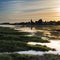 Beautiful Summer sunset landscape over low tide harbor with moor