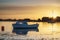 Beautiful Summer sunset landscape over low tide harbor with moor