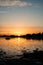 Beautiful Summer sunset landscape over low tide harbor with moor