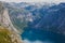 Beautiful summer vibrant view on famous Norwegian tourist place - trolltunga, the trolls tongue with a lake and mountains, Norway,