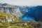 Beautiful summer vibrant view on famous Norwegian tourist place - trolltunga, the trolls tongue with a lake and mountains, Norway,