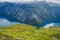 Beautiful summer vibrant view on famous Norwegian tourist place - trolltunga, the trolls tongue with a lake and mountains, Norway,