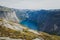 Beautiful summer vibrant view on famous Norwegian tourist place - trolltunga, the trolls tongue with a lake and mountains, Norway,