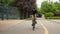 Beautiful summertime mood shot of young woman or girl riding bicycle