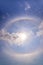 beautiful sun halo with circular rainbow around sun behide blue