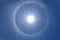 Beautiful sun halo on clear blue sky