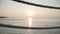 Beautiful sun reflecting in the ocean or sea behind ropes. Red sunset in the Eastern country. Beautiful Turkish nature.