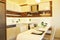 Beautiful sun side appartment with simple minimalistic modern interior design, open plan kitchen living room in sunlight.