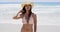 Beautiful sunbathing woman stands on shore