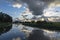 Beautiful sunbeams through the dark clouds during sunset above the canal of the Geerpolder near Zoetermeer