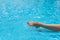 Beautiful sunburned female legs, splashes, clear turquoise pool water