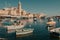 Beautiful sunny day at harbor of Malta islands. Colorful fishermen boats in vessels past small town houses