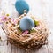 Beautiful, sunny easter greeting card - with blue colored eggs and a natural nest