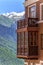 Beautiful sunny landscape of hotel building at Sichi mountain ski resort on green forest, snowy mountain peaks