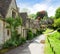 A beautiful sunny morning in Bibury, Gloucestershir, England, UK. Old street with traditional cottages