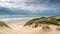 Beautiful sunny sand dunes at the shore. Ocean sea landscape on the beach with calming waves.