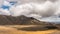 Beautiful sunny summer day with dramatic grey clouds sky over volcano mountains nature in New Zealand Time lapse