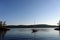 A beautiful sunny summer day in the gulf islands with sailboats resting on the calm ocean surrounded by scenic forested coastline