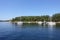 A beautiful sunny summer day in the gulf islands with sailboats resting on the calm ocean surrounded by scenic forested coastline