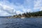 A beautiful sunny summer day in the gulf islands with sailboats resting on the calm ocean surrounded by scenic forested coastline