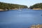 A beautiful sunny summer day in the gulf islands with sailboats resting on the calm ocean surrounded by scenic forested coastline