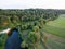 A beautiful sunny view of the forest, fields and river from above with a drone