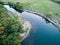 A beautiful sunny view of the forest, fields and river from above with a drone