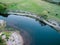 A beautiful sunny view of the forest, fields and river from above with a drone