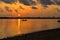 A beautiful sunrise with cloudy sky on the beach.