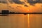 A beautiful sunrise with cloudy sky on the beach.