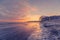 Beautiful sunrise at a frozen sea shore