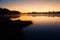 A beautiful sunrise on a lake with a raising mist. Beautiful morning in wetlands in Latvia.