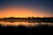 A beautiful sunrise on a lake with a raising mist. Beautiful morning in wetlands in Latvia.