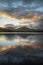 Beautiful sunrise landscape image looking across Loweswater in the Lake District towards Low Fell and Grasmere with vibrant