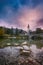 Beautiful sunrise landscape of lake Bohinj, Triglav National Park, Julian Alps in Slovenia with church and arch bridge on blue