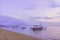 Beautiful sunrise and old wooden fishing boats view from Sanur beach, Bali island. Footprints in the sand