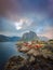 Beautiful sunrise over Hamnoy, fishermen village with the typical red houses of the Lofoten Islands , Norway