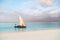 Beautiful sunrise over ocean with fishing boat, fishermen, Nungwi, Kendwa, Zanzibar island, Tanzania