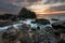 Beautiful sunrise over the sea. Cloudy dramatic sky, big waves. Magnificent cloudscape near the shore