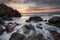 Beautiful sunrise over the sea. Cloudy dramatic sky, big waves. Magnificent cloudscape near the shore