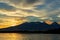 Beautiful sunrise over volcanoes Kluchevskaya group with reflection in the river Kamchatka.