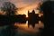 Beautiful sunrise scenery with Galway cathedral under dramatic orange sky reflected in the Corrib River in Ireland