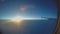 Beautiful sunrise in sky, plane wing seen through aircraft window, passenger pov