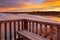 A beautiful sunrise at southport port noarlunga south australia overlooking the wooden staircase ocean and cliffs on the 30th