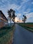 Beautiful sunrise, street, building, field and tree in a village in the afternoon